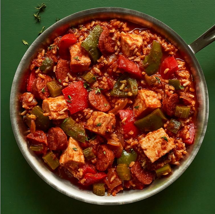 The Cajun Inspired Turkey Jambalaya is red in color with a green background